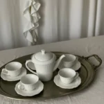 Camellia fine porcelain tea set with teapot, cups and saucers arranged on a silver tray