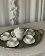 Camellia fine porcelain tea set with teapot, cups and saucers arranged on a silver tray