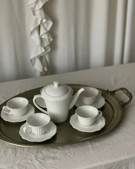 Camellia fine porcelain tea set with teapot, cups and saucers arranged on a silver tray