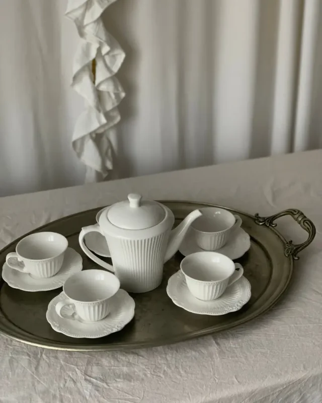 Camellia fine porcelain tea set with teapot, cups and saucers arranged on a silver tray