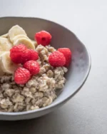 Terra stoneware bowl of oatmeal topped with raspberries and banana