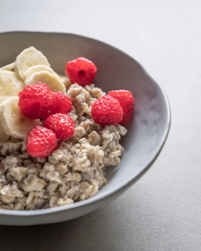 Terra stoneware bowl of oatmeal topped with raspberries and banana